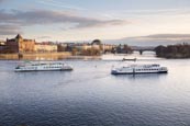 Thumbnail image of view of the Vlatva Rover from the Charles Bridge with tourist boats, Prague, Czech Republic