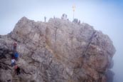 People On The Zugspitze Summit By The Summit Cross, Bavaria, Germany