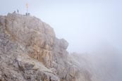 People On The Zugspitze Summit By The Summit Cross, Bavaria, Germany
