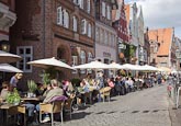 Thumbnail image of Am Stintmarkt with people sitting outside restaurants, Luneburg, Lower Saxony, Germany