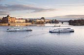 View Of The Vlatva Rover From The Charles Bridge With Tourist Boats, Prague, Czech Republic