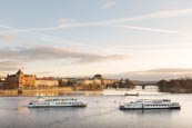 View Of The Vlatva Rover From The Charles Bridge With Tourist Boats, Prague, Czech Republic