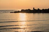 Thumbnail image of sunset over the sea at Ahrenshoop man sea fishing off rocks, Mecklenburg-Vorpommern, Germany