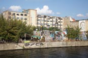 Buildings Beside The River Spree In Friedrichshain, The Freie Republik Yaamaica Beach Bar With An Ab