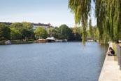Landwehr Canal, Kreuzberg People Sitting On The Böcklerpark And Leisure Boats On The Canal, Berlin, 