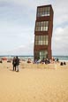 Thumbnail image of People on the beach at Barceloneta with Rebecca Horns sculpture  L’Estel Ferit (The Wounded Shooting